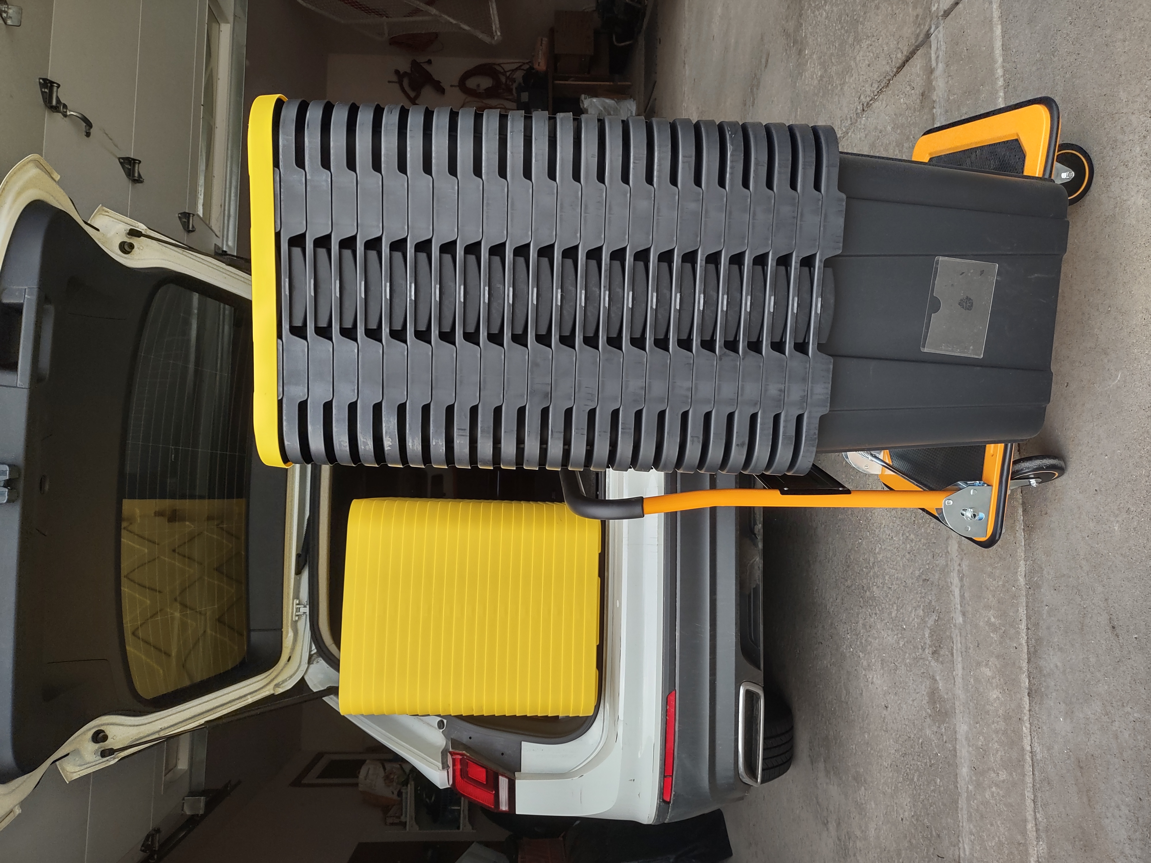 Stack of reusable moving totes loaded on a dolly ready for delivery in Buffalo NY